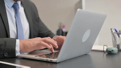 Close up of Businessman Working on Laptop