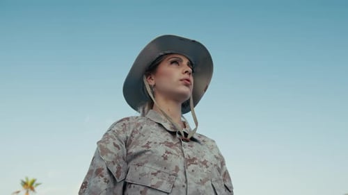 Young Adult in Camouflage Saluting Outside