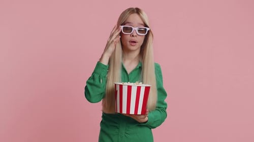 Woman Shocked and Eating Popcorn at Movie