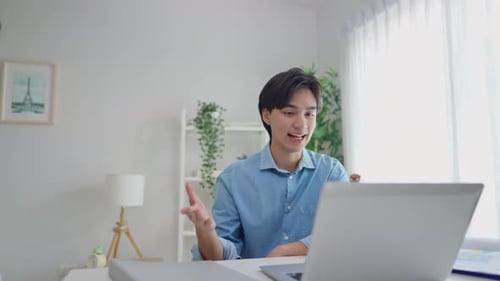 Young Adult Participating in Online Meeting at Home