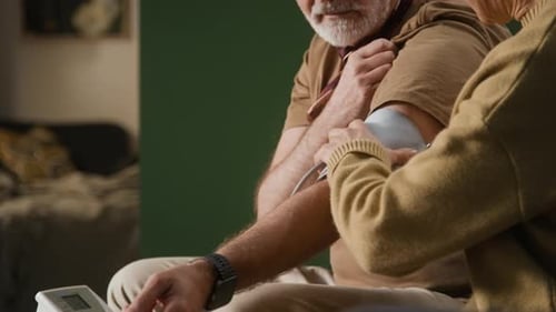 Senior Couple Taking Blood Pressure Reading at Home