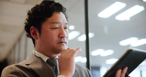 Japanese man, tablet and thinking in office for business, stock market research