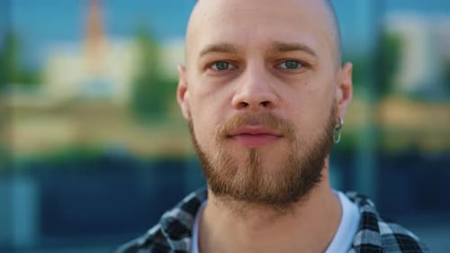 Portrait of the Smiled Beard Caucasian Man Standing on the Street Looking at the Camera