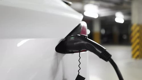 Electric Car Being Charged in Underground Parking Garage