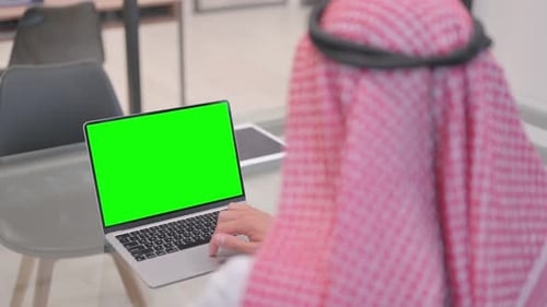 Arab Man Working on Green Screen Laptop