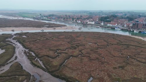 Aerial view of Wells-next-the-Sea marshland and town with boats and tidal waterways