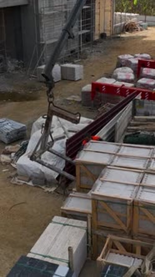 Vertical Video Construction Site View Crane Unloading and Builders Working