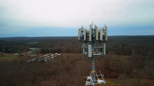Aerial Reverse Shot of Cell Phone Tower in Forest. Drone Footage
