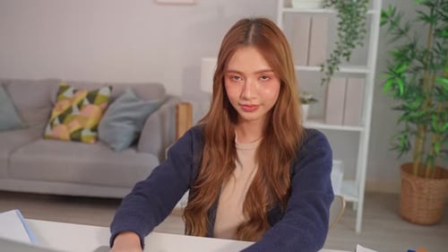 Smiling Young Woman Works on Laptop at Home