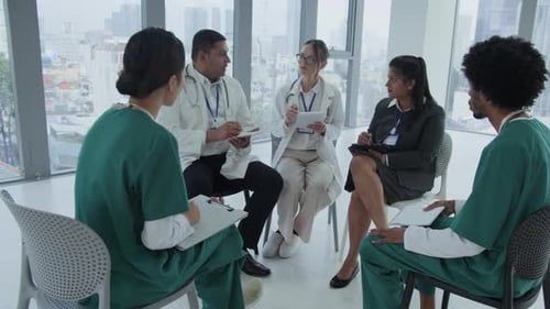 Team of Healthcare Workers Having Meeting in Clinic