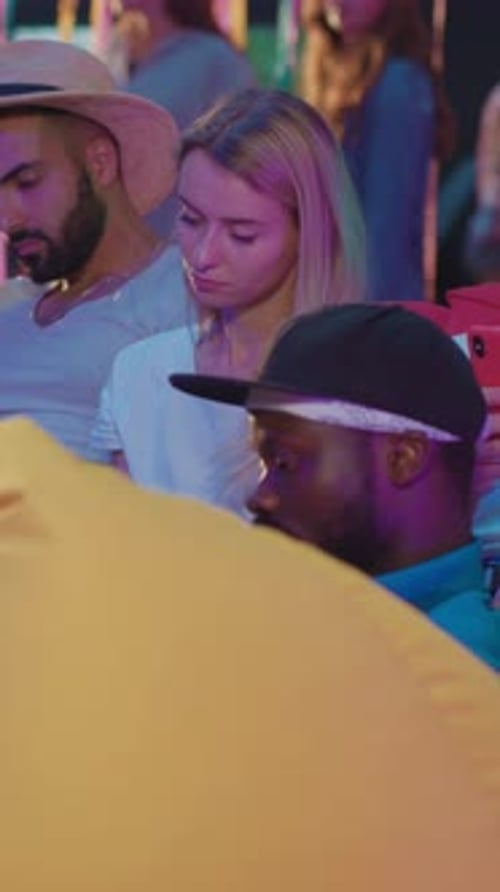 Young Adults Sitting Together Looking at Phones