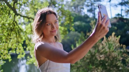 Young Woman Taking a Selfie in a Park