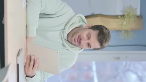 Vertical Video of Online Video Chat on Tablet by Young Man