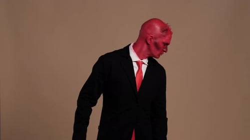 Red Devil Businessman Making Gestures on Solid Background