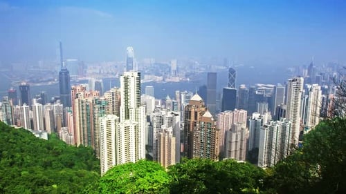 Hong Kong city skyline time lapse from victoria peak under sunny skies
