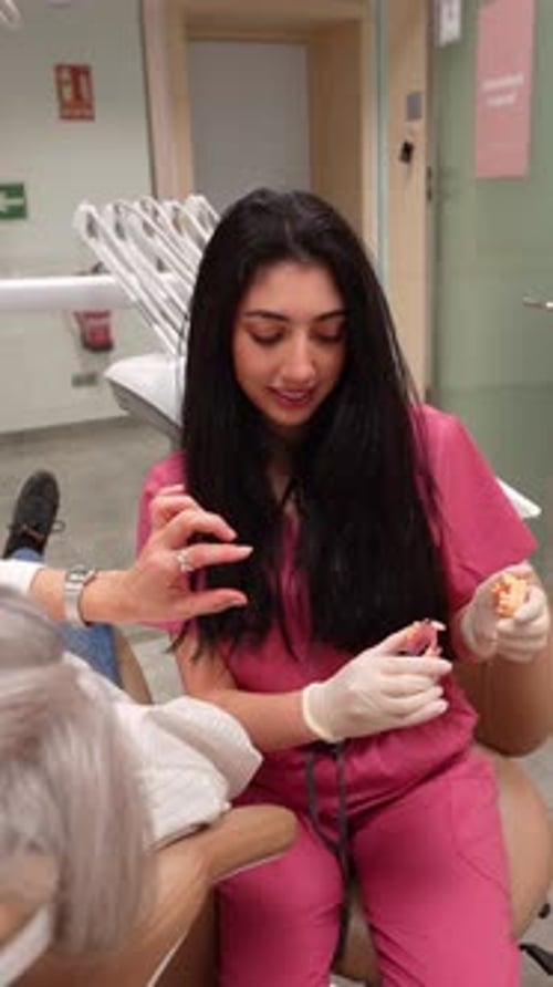 Dentist Explains Procedure to Patient in Office