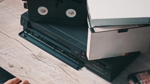 Pulls Out VHS Tape Cassette From a Vintage VCR Recorder