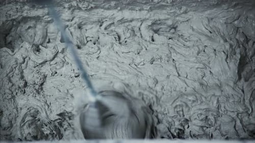 Gray Material Being Mixed with a Machine