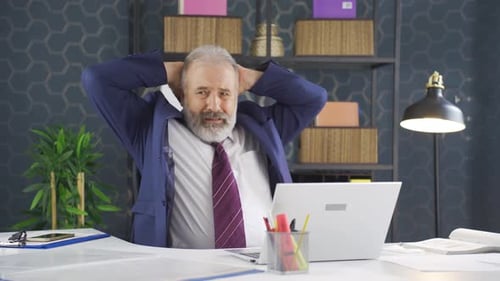 Stressed Businessman Working on Laptop in Office