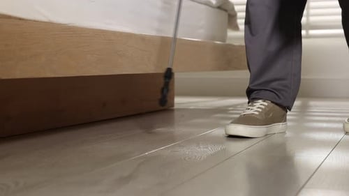 Cleaning service spraying disinfectant in modern bedroom