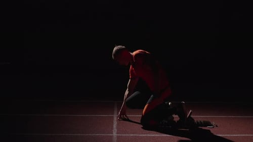 Sportsman Standing In Low Start Position Leaning On Starting Blocks Run Workout Of Sprinter