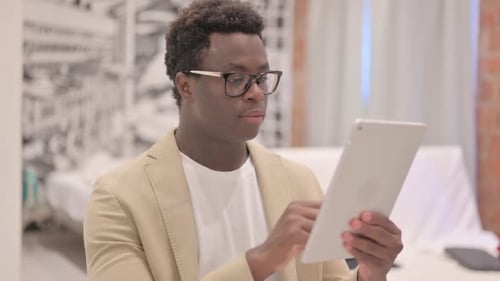 Young Adult Using Tablet Device Indoors