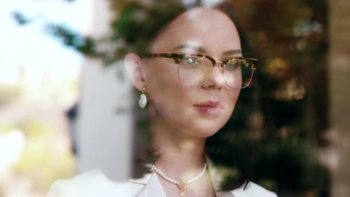 Elegant Woman in Blazer and Glasses Posing Indoors