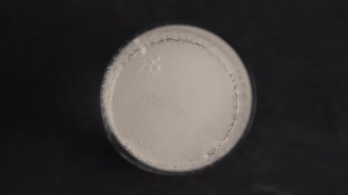 Super slow motion sparkling water refreshing bubbles in a black background glass