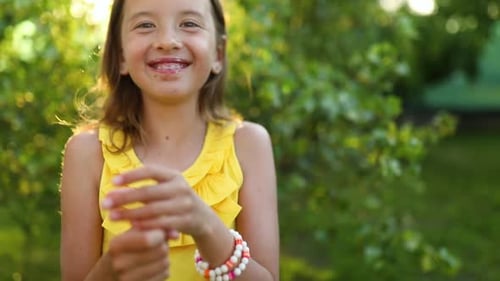 Happy girl with braces eating italian ice cream cone
