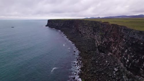 Krisuvikurberg Cliffs Ocean Aerial View Landscape. Black Rock Beach Fly Over Cliffs to Green Fields