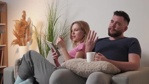 Couple Relaxing Together on Couch at Home