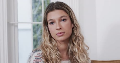 Young Woman Smiling in Natural Light Indoors
