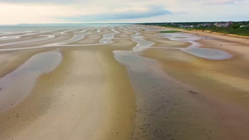 Low Tide Beach with Rippled Sandbars, Tide Pools, and Open Shoreline