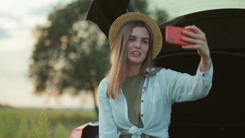 Young Woman Video Calling on Phone in Rural Setting