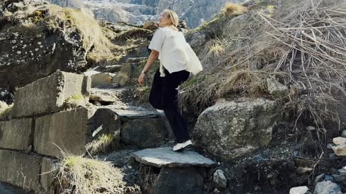 Woman Hiking on Mountain Trail on Sunny Day
