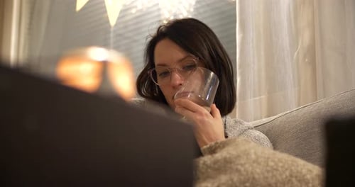 Woman Reading a Book and Relaxing at Home