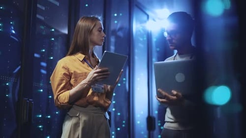 Engineers Inspect Data Center with Laptop and Tablet