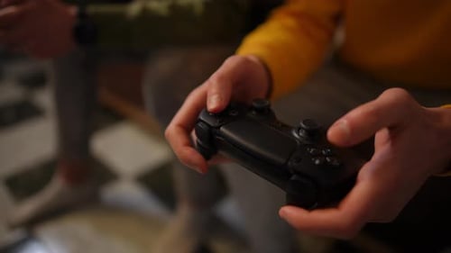 Hands Holding Gaming Controller Playing Video Games