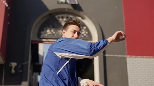 Dancing Young Man Flipping Over In Street
