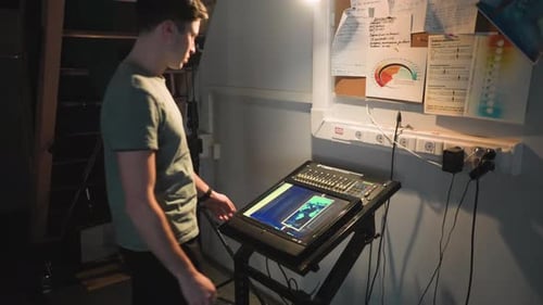 Young Adult Operating Sound Mixing Board