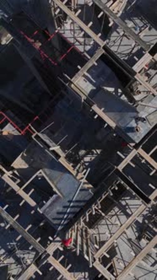 Vertical Video of Residential Construction With Workers Pouring Concrete and Erecting Wall