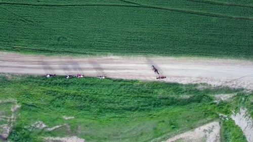 Horseback riding in a green Badlands terrain, aerial footage