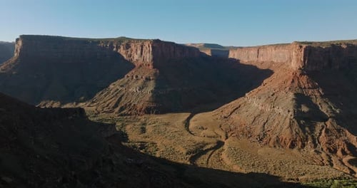 Stunning Aerial View of Moab Canyon's Rugged Landscape and Clear Blue Sky