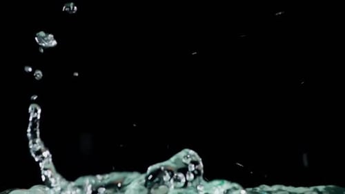 Water Pouring and Splashing Against Black Background