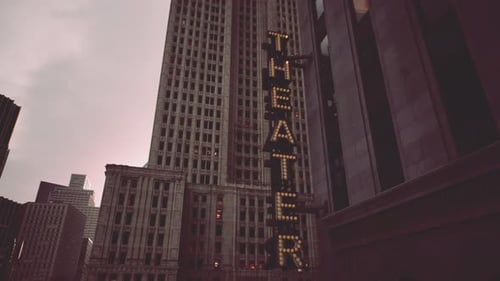 A Tall Building with a Prominent Theatre Sign