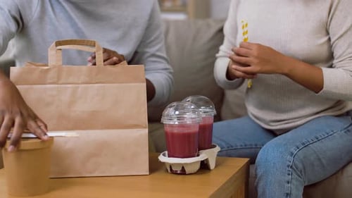 Couple Enjoying Takeout and Smoothies at Home