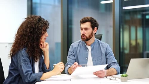 Business Meeting Colleagues Collaborate on Contract in Modern Office
