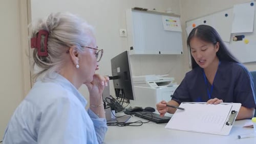 Healthcare Worker Explains Test Results to Senior Patient