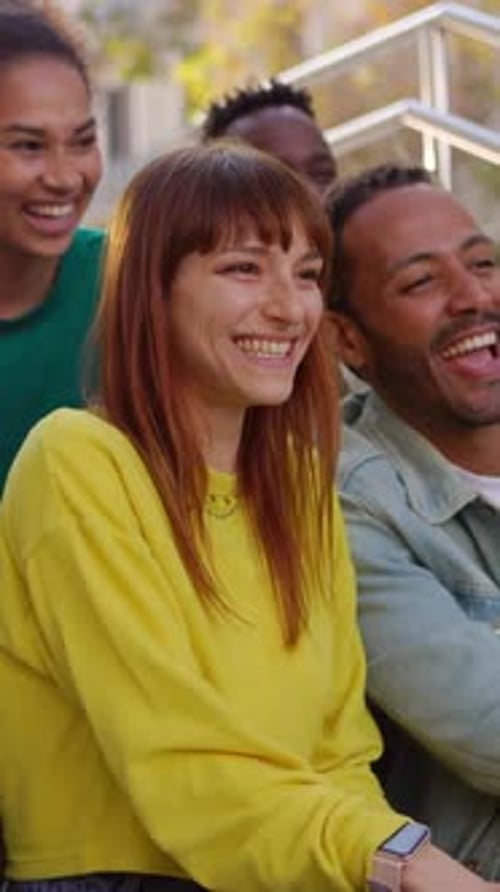 Friends Laughing Together on City Stairs Outdoors