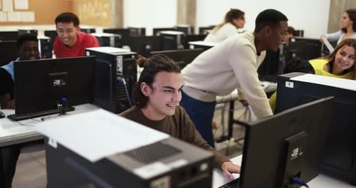 Young Multiracial Students Using Computer Inside Classroom at School Academic